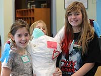 Fireweed Academy students with a mock spill worker dressed in protective garb.