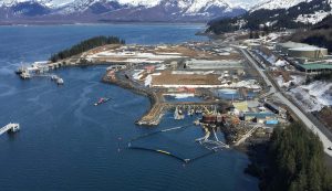 This aerial photo shows several layers of oil spill boom containing the oil while workers cleaning up the spill. 