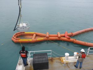 Photo of Crucial skimmers and Buster spill boom systems with caption: The combination of the new Crucial skimmers with Buster boom systems have increased oil skimming efficiency since 1989.
