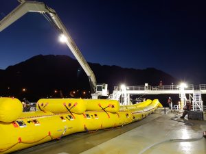 Photo of crews practicing oil spill response at night. 