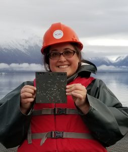 Photo of staff member holding a settling plate from a visual monitoring trip.