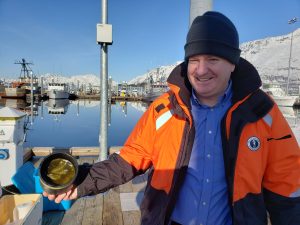 In this photo, a Council staff member holds a sample, which is green due to the tiny plants, or phytoplankton, in the sample. 