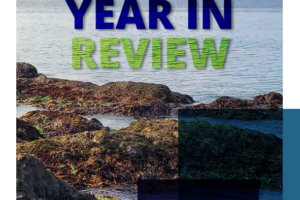 Front cover of the report. Image is of a rocky beach in Prince William Sound covered with mussels and other tidal critters. Mountains and ocean in the background. Clicking on the image will download a PDF of the report.