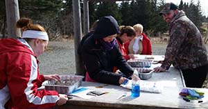 Elmira College students participate in a mock oil spill cleanup.