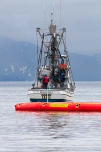 A fishing vessel pulls oil spill boom during a recent drill.