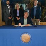 Right: Governor Walker signs the law, witnessed by council staff member Steve Rothchild; the bill’s sponsor, Rep. Cathy Munoz of Juneau; and Alaska Department of Environmental Conservation’s Commissioner Larry Hartig. Photo courtesy of the office of Governor Walker.