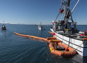 A fishing vessel practices using oil spill boom and skimmers during fishing vessel training last year. The fishermen bring valuable knowledge about local waters during a spill response. Fishing vessel response was a major improvement in oil spill prevention and response since the Exxon Valdez oil spill. Photo by Cathy Hart.