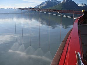 A vessel sprays water as practice for applying dispersants during an oil spill drill.