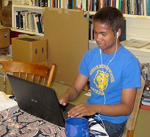 Rafael Bitanga, environmental intern for the Baranof Museum, transcribes Kodiak resident’s stories about the Exxon Valdez oil spill. Photo courtesy of the Baranof Museum.