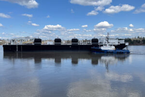 This photo shows a new oil spill response barge with an escort tug alongside the barge. 