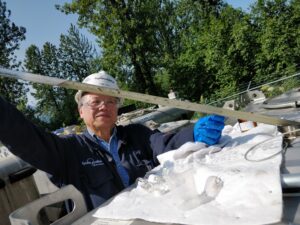 A recent photo of Tang performing an analysis of a substance. He appears older in this photo than the photo towards the top of this page. The two images help demonstrate how long Tang has been working at Alyeska.