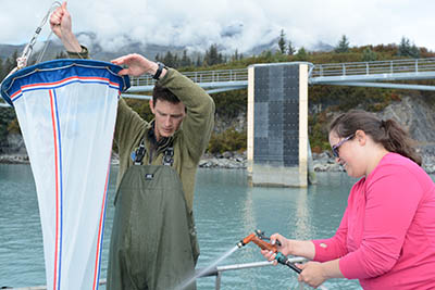 Council staffers Austin Love and Nelli Vanderburg work with the Smithsonian staff to survey Port Valdez. Photo by Kim Holzer.