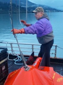 In this image, Shelton Gay, an oceanographer with the Prince William Sound Science Center and principal researcher for this project, prepares to launch a bouy.